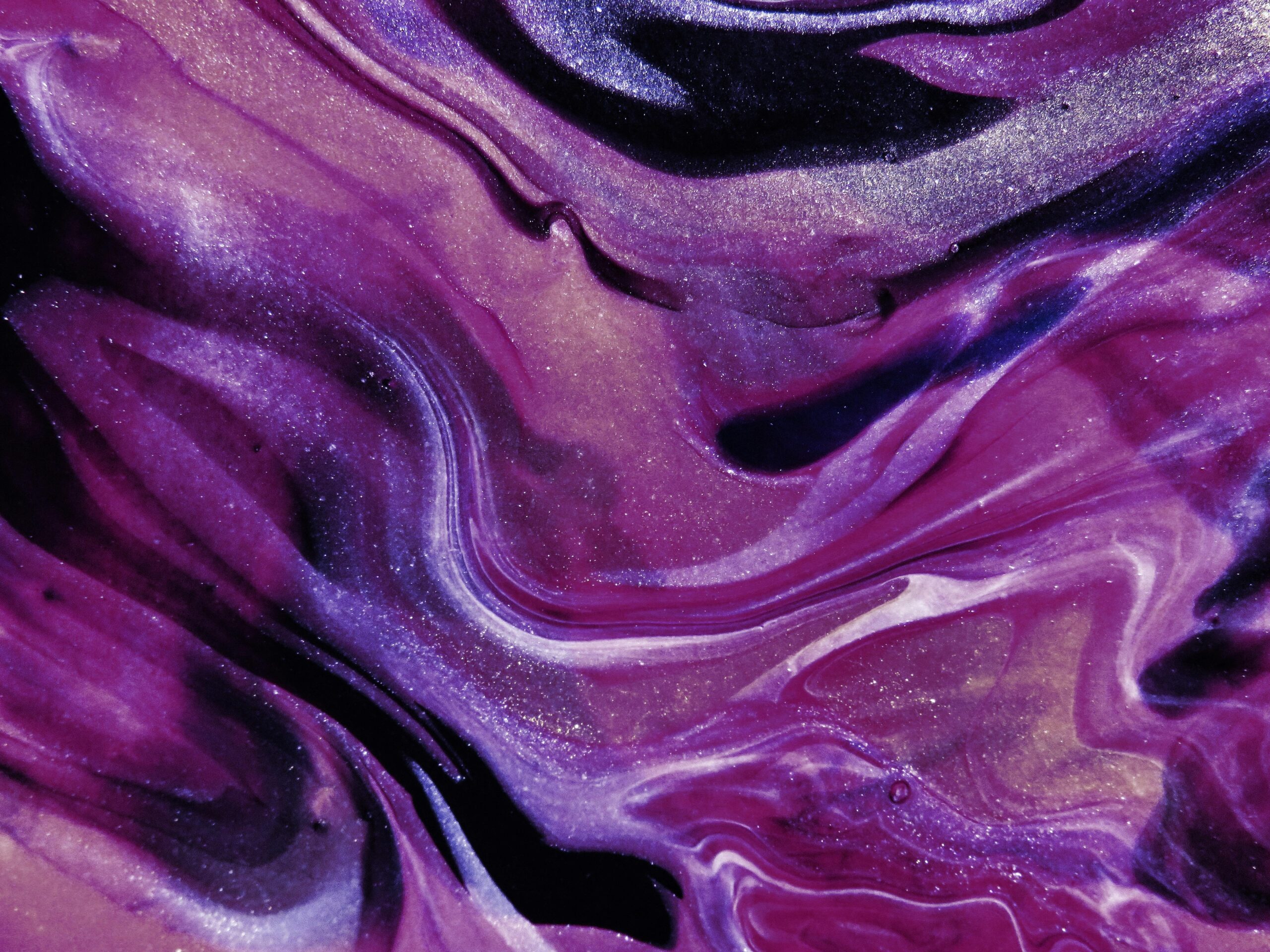 Glittery abstract art with vibrant purple and lilac swirls, perfect for creative projects.